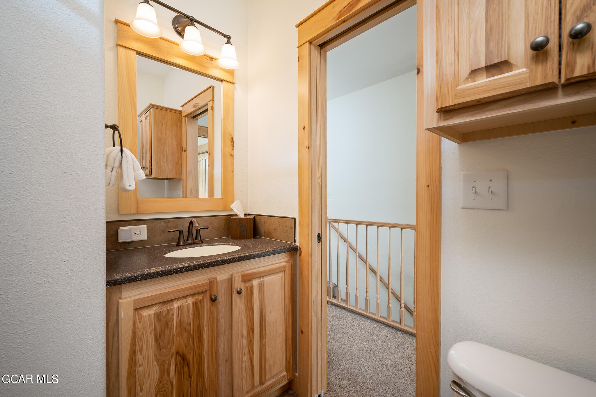 107 Edgewater Circle Granby, CO 80446 - Photo 31 of 51 a bathroom with a granite countertop sink vanity mirror and toilet