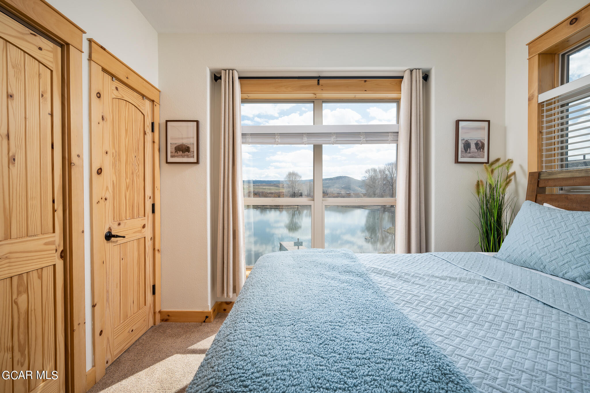 107 Edgewater Circle Granby, CO 80446 - Photo 34 of 51 a bedroom with a bed and a large window with outer view