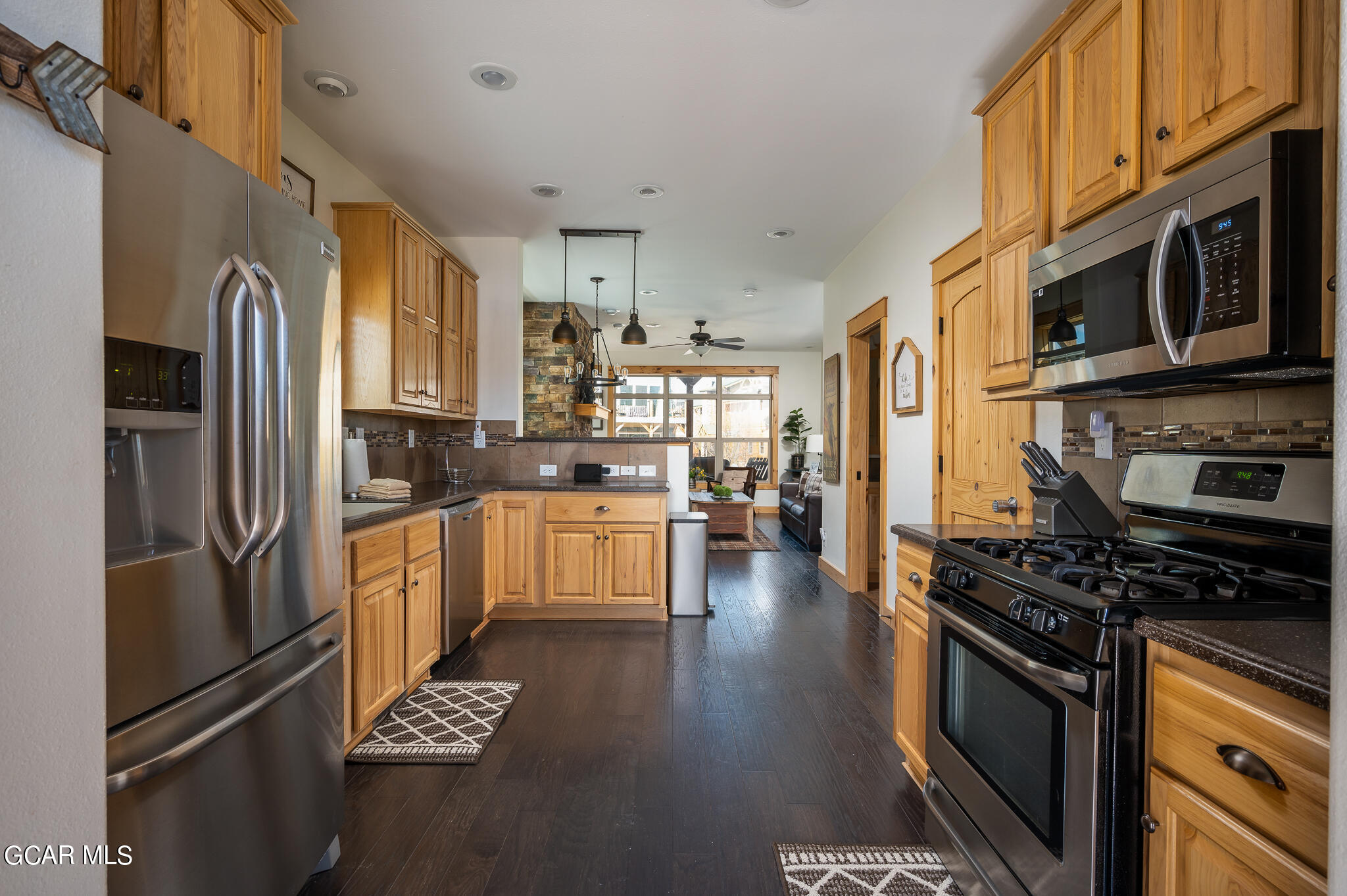107 Edgewater Circle Granby, CO 80446 - Photo 7 of 51 a kitchen with stainless steel appliances kitchen island granite countertop a refrigerator stove and sink