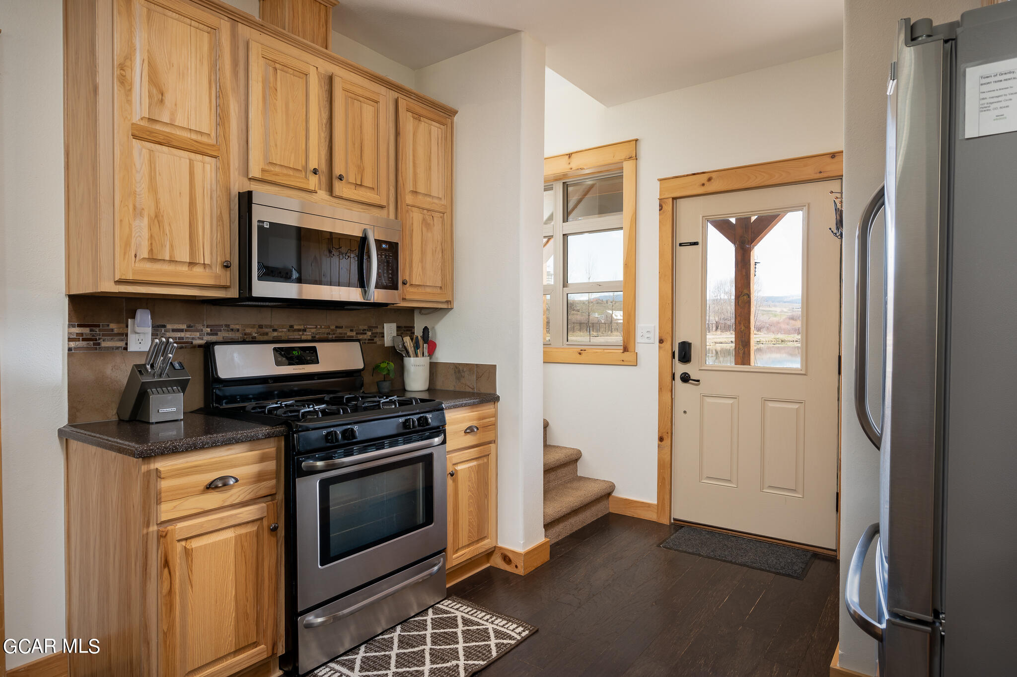 107 Edgewater Circle Granby, CO 80446 - Photo 8 of 51 a kitchen with granite countertop a stove a sink and a microwave