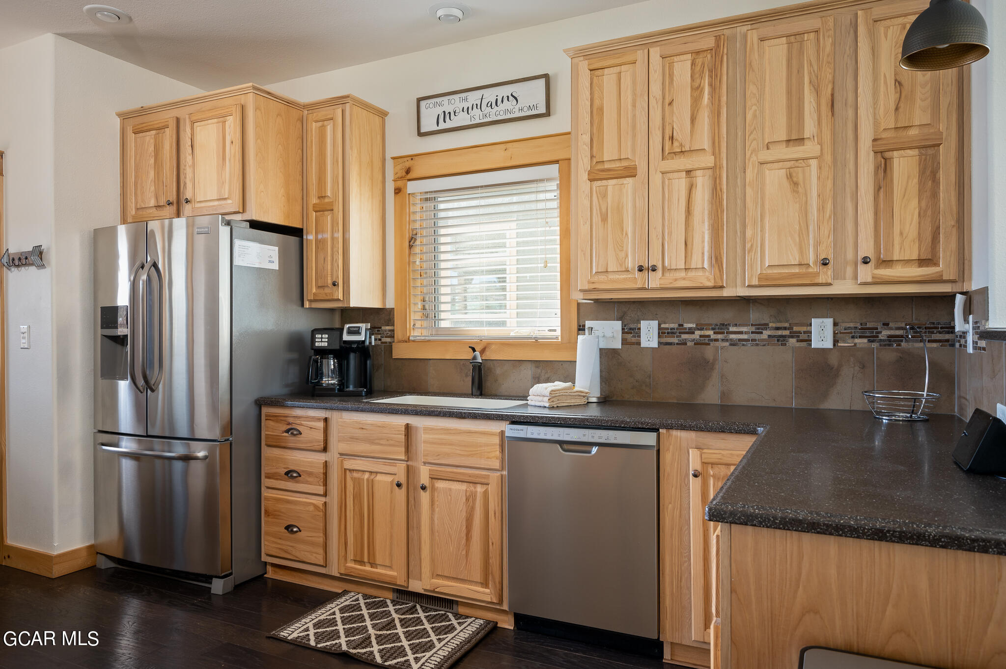 107 Edgewater Circle Granby, CO 80446 - Photo 9 of 51 a kitchen with stainless steel appliances granite countertop a refrigerator sink and cabinets