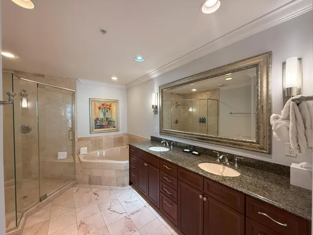 a spacious bathroom with a bathtub shower sink and mirror