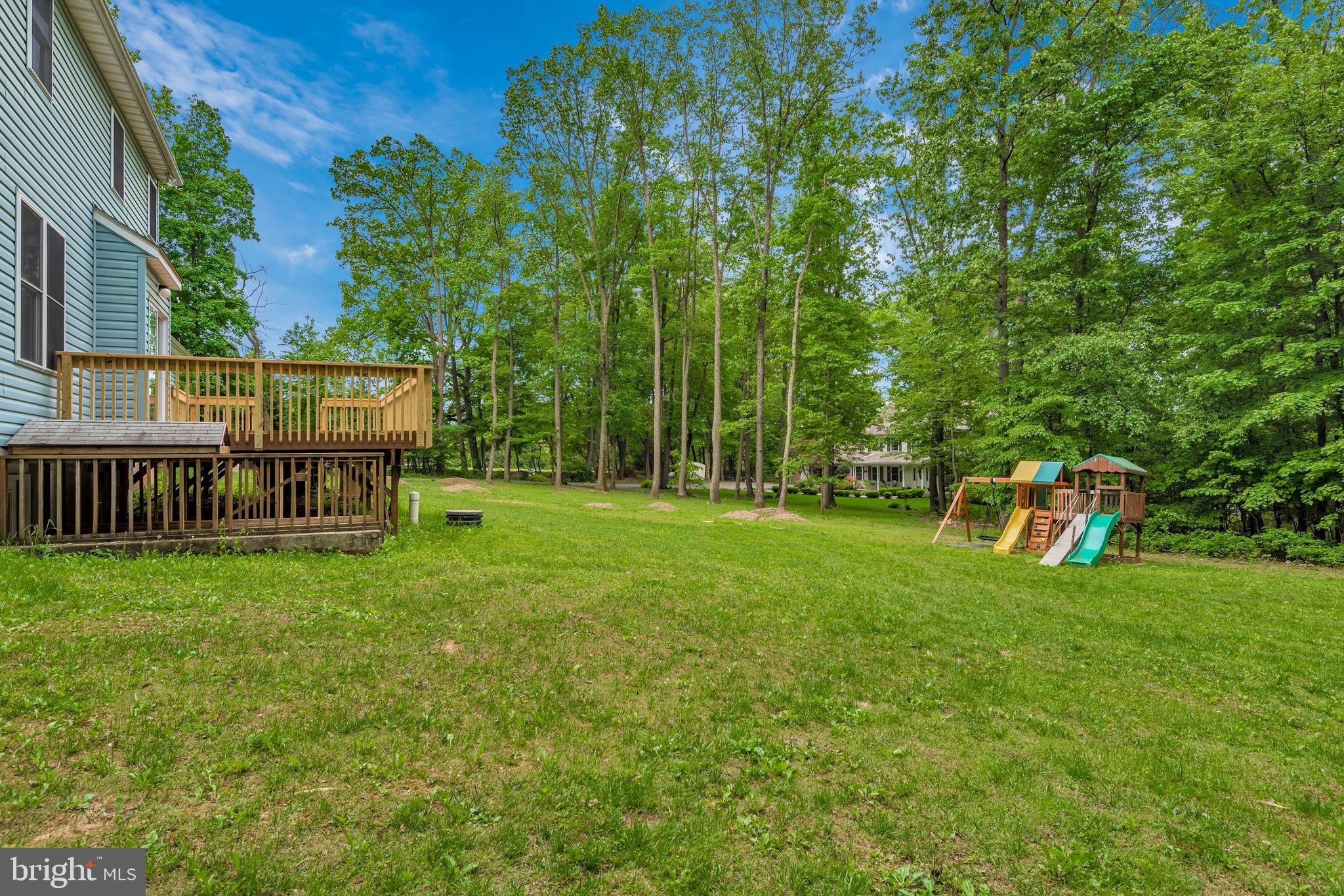 3522 Hooper Road New Windsor, MD 21776 - Photo 38 of 43 a view of a deck with a small yard and large trees