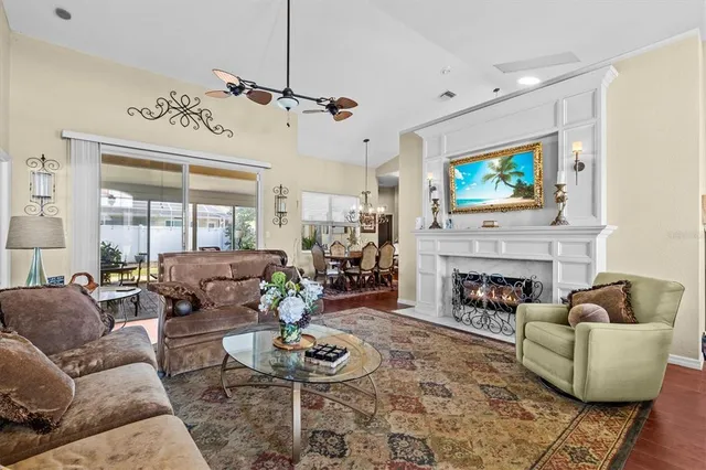 a living room with furniture a fireplace and a flat screen tv