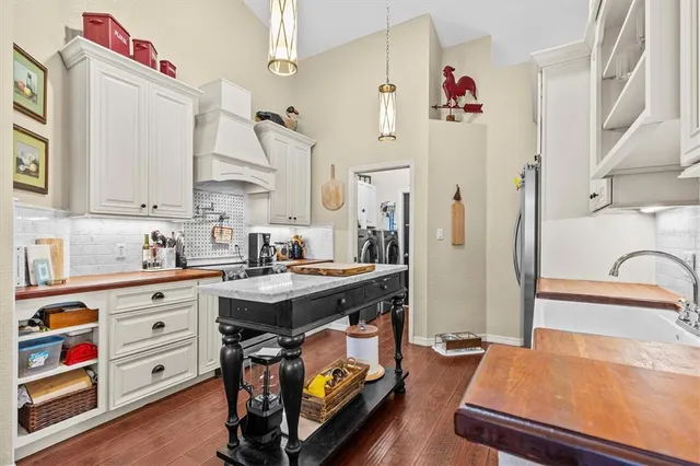 a kitchen with stainless steel appliances a stove a sink and a refrigerator