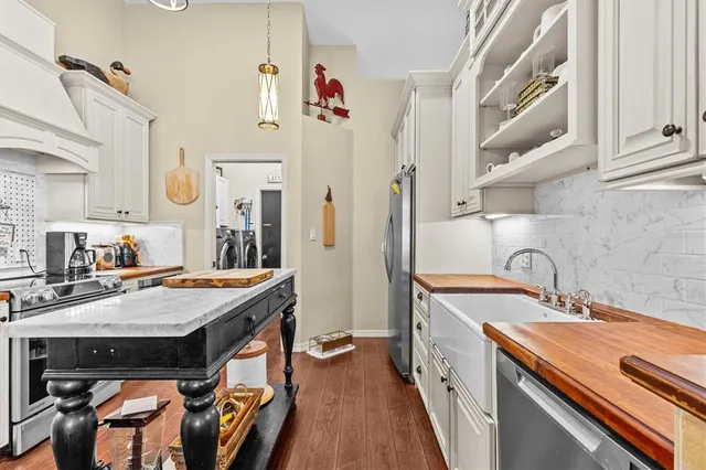 a view of a dining room with furniture a chandelier and wooden floor