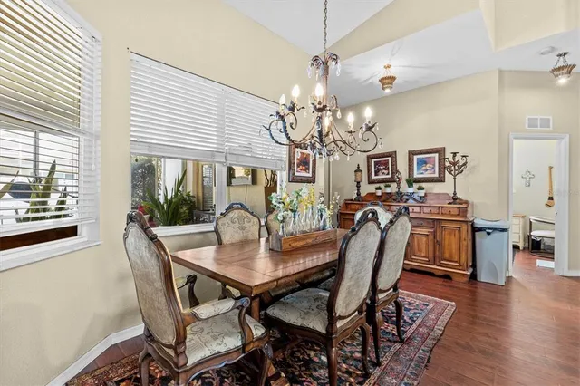 a view of a dining room with furniture and wooden floor