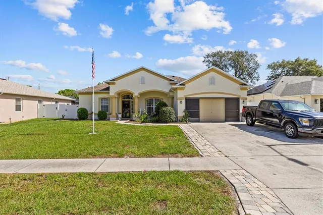 a front view of a house with a garden and yard