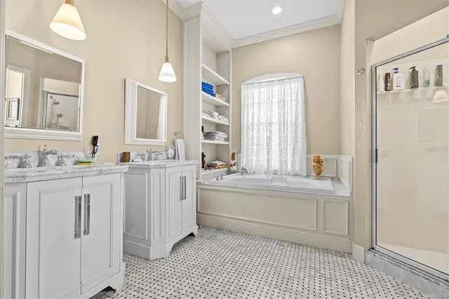 a spacious bathroom with a double vanity sink a mirror and a bathtub
