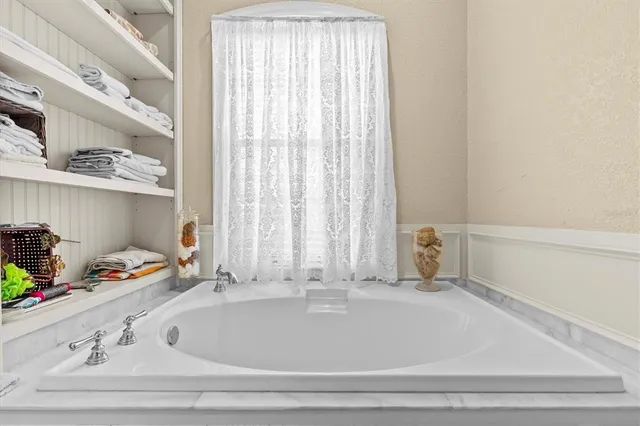 a bathroom with white cabinets