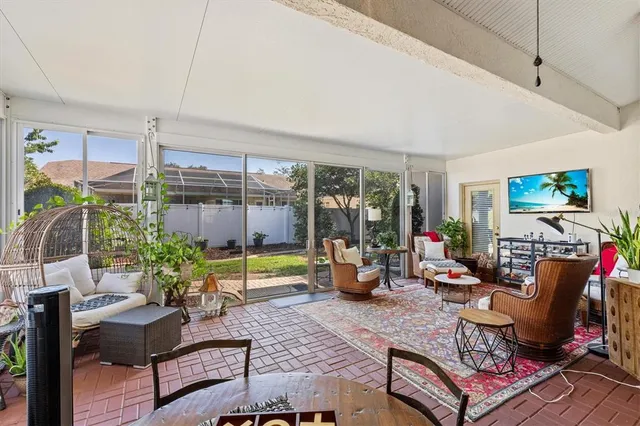 a living room with furniture fireplace and a large window