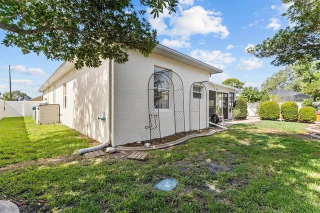 a view of a backyard with plants and a bench