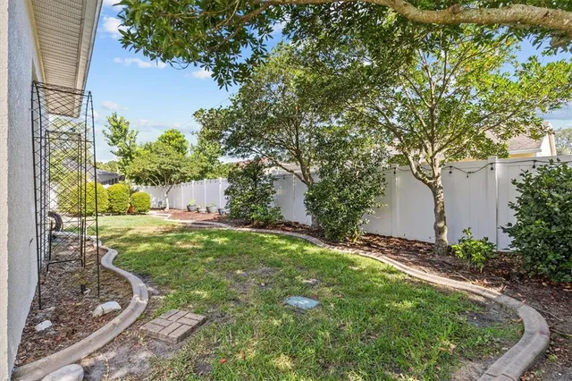 a view of a house with backyard and sitting area