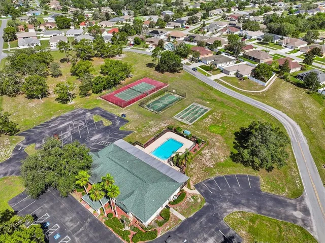 an aerial view of residential houses with outdoor space