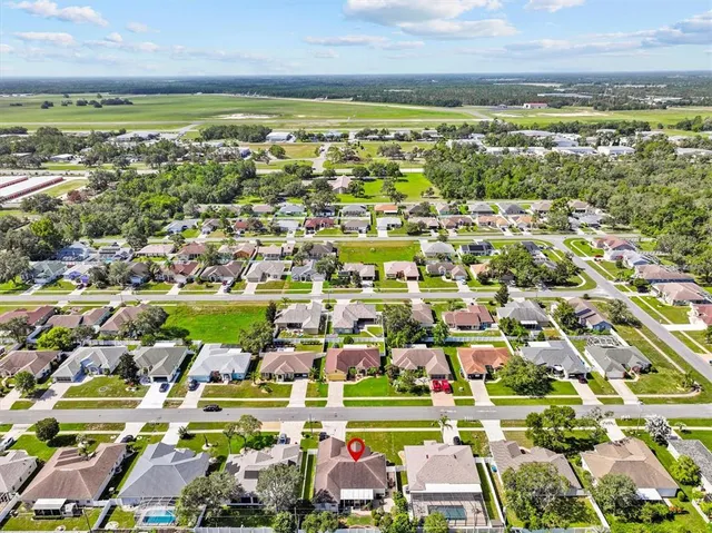 an aerial view of residential houses with outdoor space