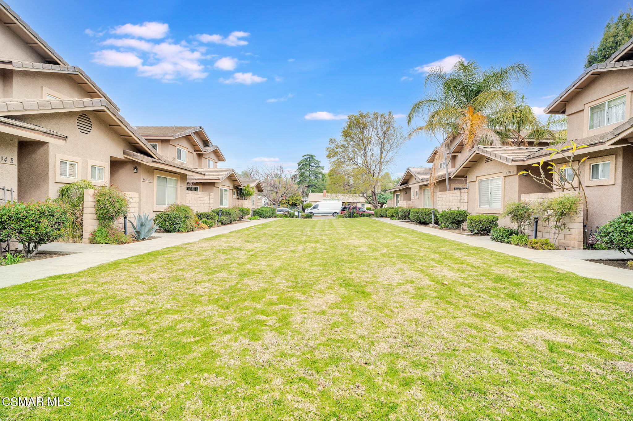 4492 Apricot Road, Unit B Simi Valley, CA 93063 - Photo 1 of 28 a view of a white house with a swimming pool and a yard