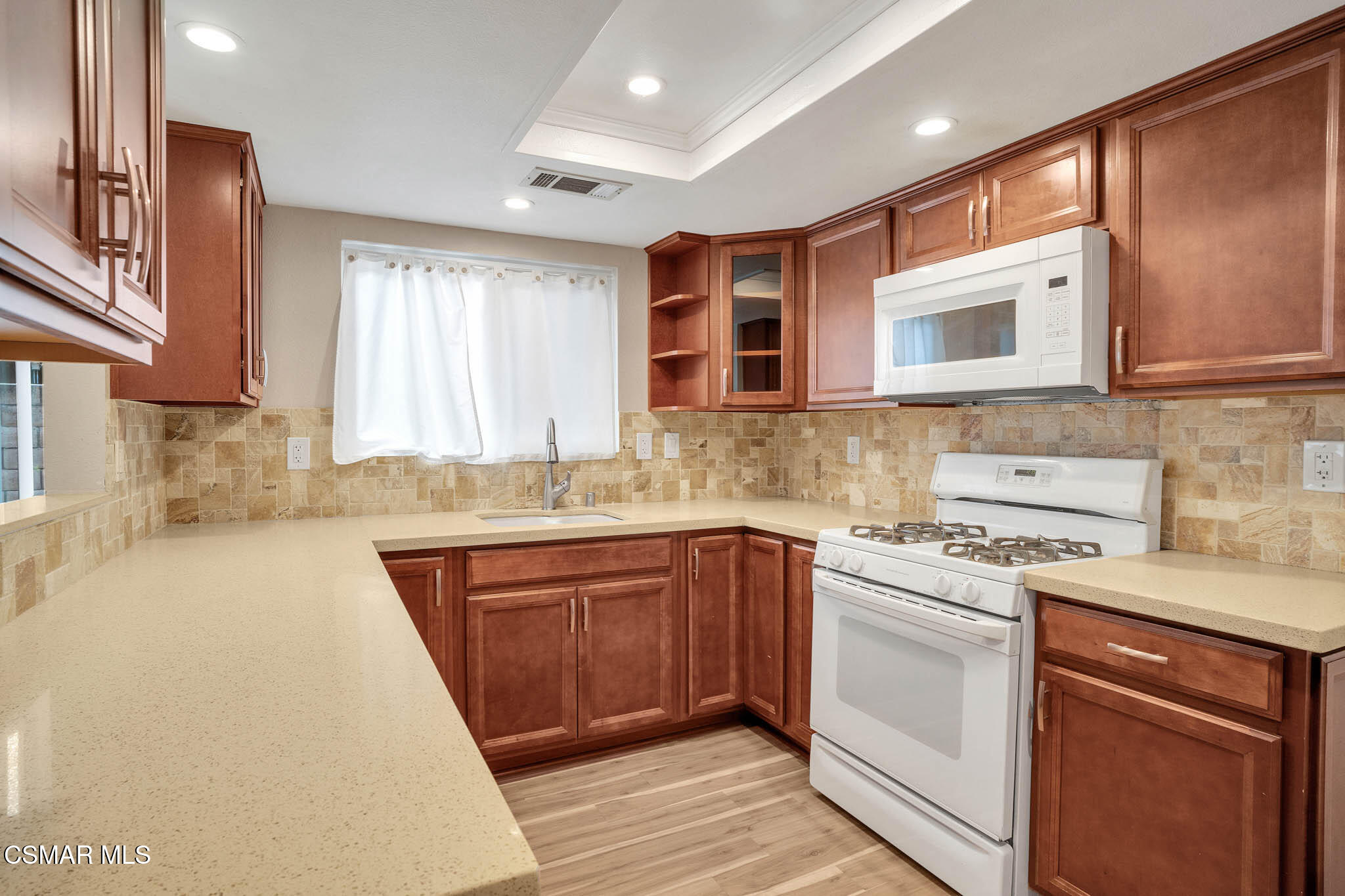 4492 Apricot Road, Unit B Simi Valley, CA 93063 - Photo 12 of 28 a kitchen with stainless steel appliances granite countertop a sink stove and cabinets