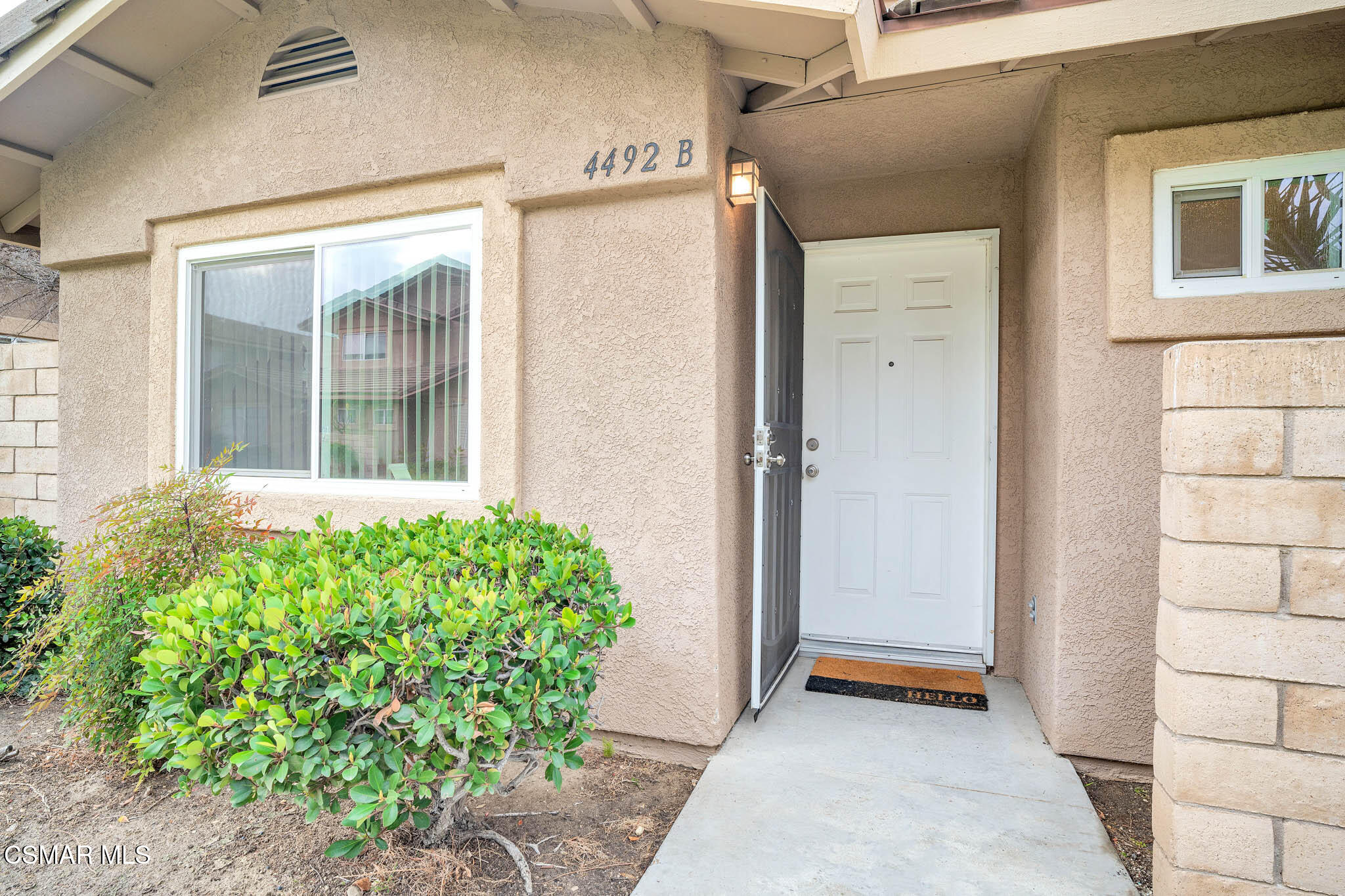 4492 Apricot Road, Unit B Simi Valley, CA 93063 - Photo 4 of 28 a front view of a house with a blue garage