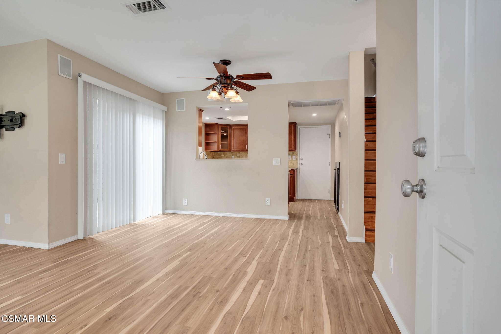 4492 Apricot Road, Unit B Simi Valley, CA 93063 - Photo 5 of 28 a view of a hallway with wooden floor and a chandelier fan