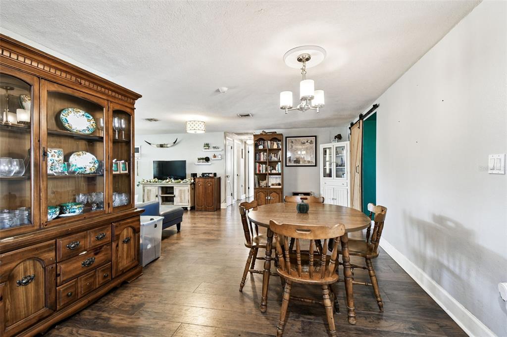 5831 1st Avenue New Port Richey, FL 34652 - Photo 9 of 22 a view of a dining room with furniture and wooden floor