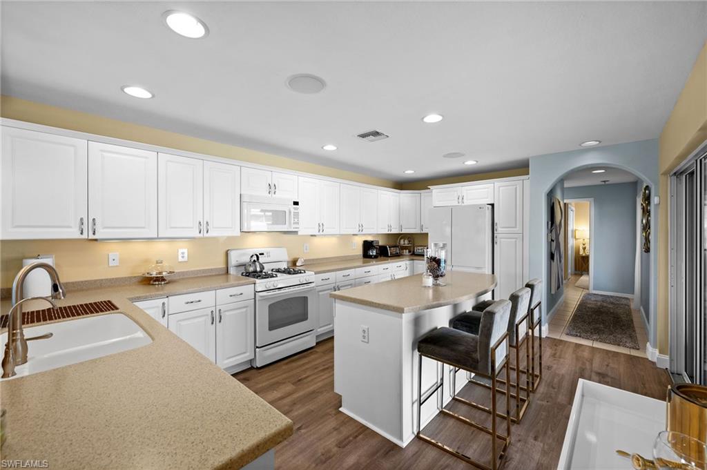 9079 Astonia Way Estero, FL 33967 - Photo 12 of 37 a kitchen with a sink cabinets and stainless steel appliances