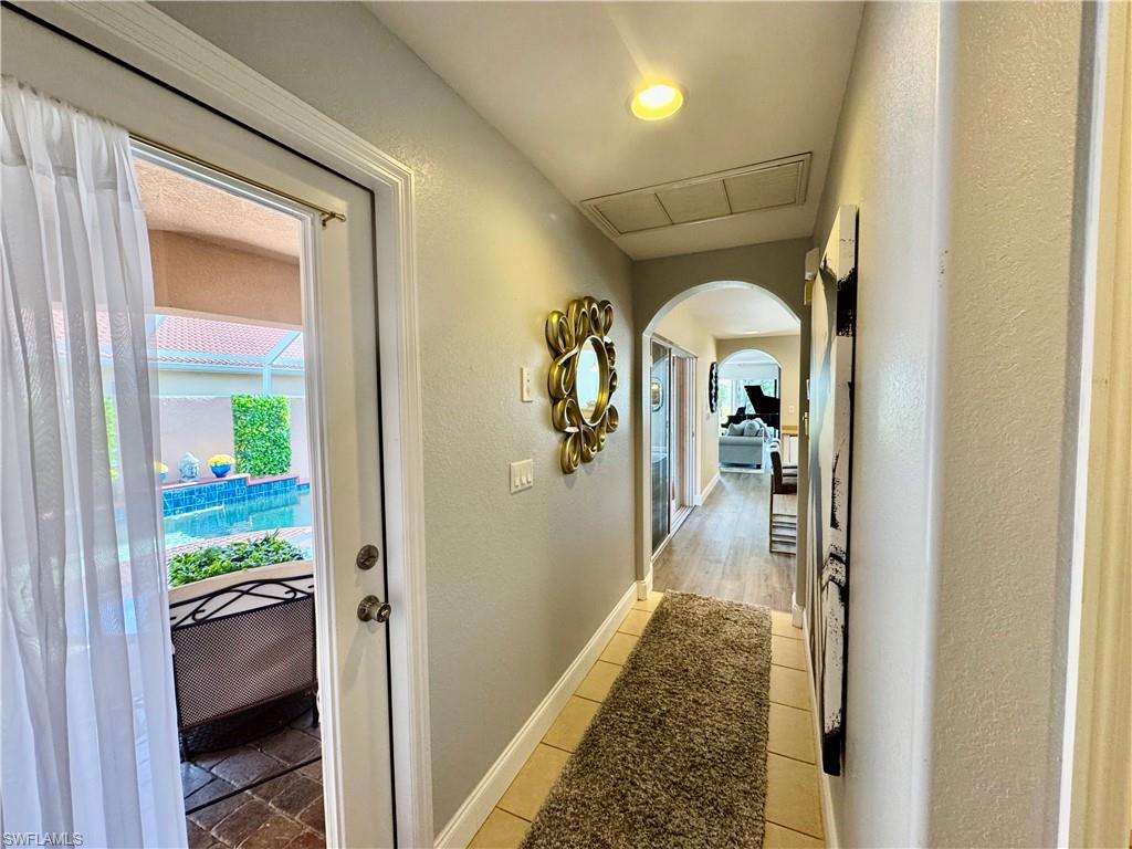9079 Astonia Way Estero, FL 33967 - Photo 18 of 37 a view of a hallway view with wooden floor staircase and living room