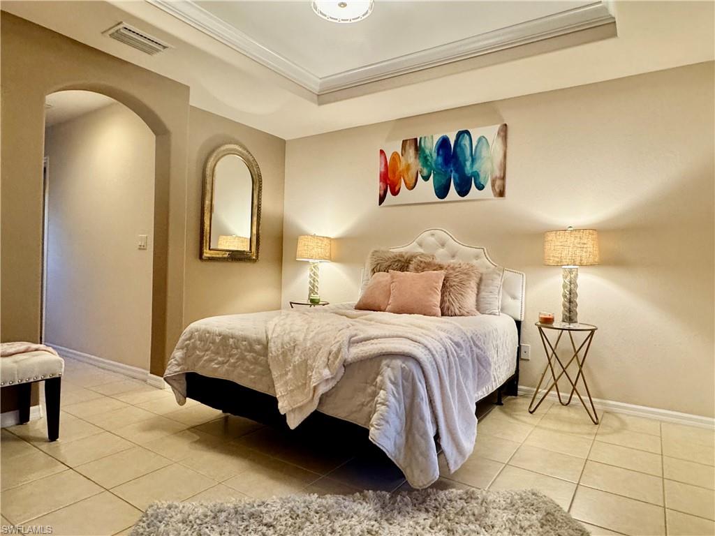 9079 Astonia Way Estero, FL 33967 - Photo 23 of 37 a bedroom with a bed and a painting on the wall