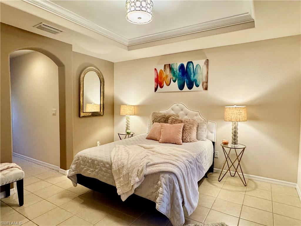 9079 Astonia Way Estero, FL 33967 - Photo 24 of 37 a bedroom with a bed and a painting on the wall