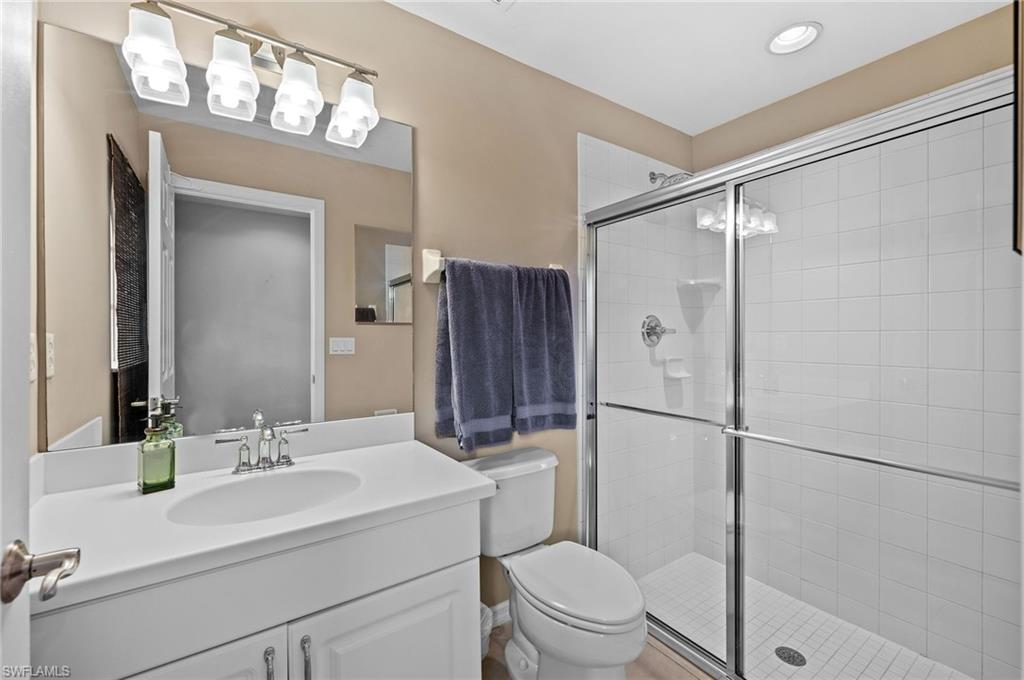9079 Astonia Way Estero, FL 33967 - Photo 25 of 37 a bathroom with a sink a toilet and a mirror