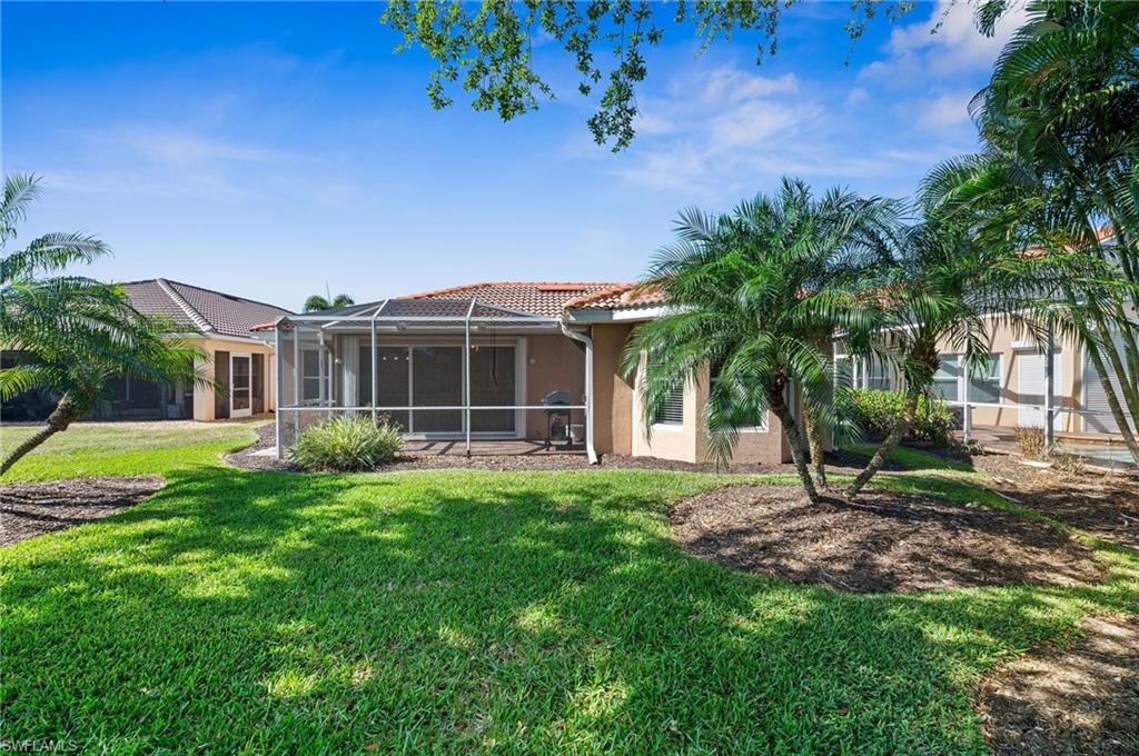 9079 Astonia Way Estero, FL 33967 - Photo 26 of 37 a view of a house with a yard and potted plants
