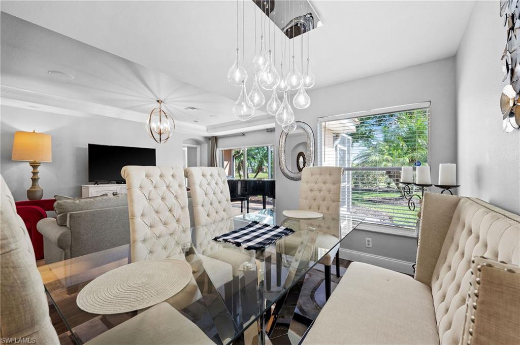 9079 Astonia Way Estero, FL 33967 - Photo 10 of 37 a view of a dining room with furniture a livingroom and chandelier