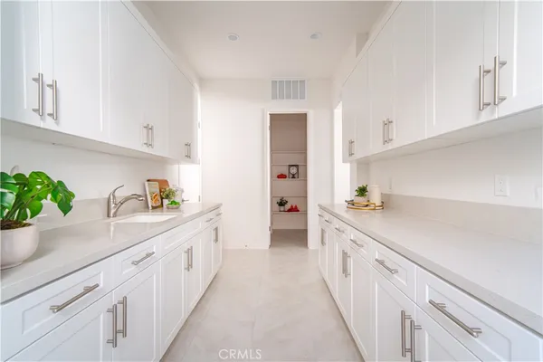 a kitchen with white cabinets
