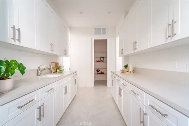 a kitchen with white cabinets