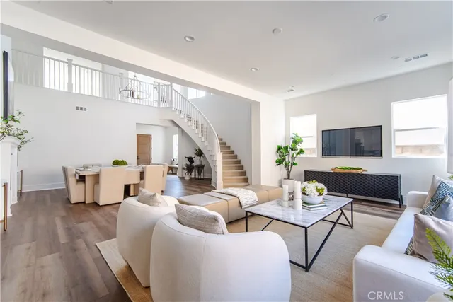 a living room with furniture wooden floor and a flat screen tv