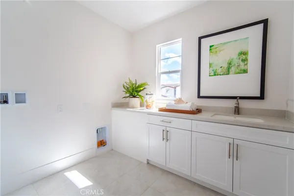 a bathroom with a granite countertop sink and a window