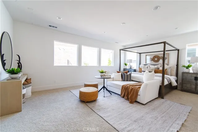 a spacious bedroom with a bed and a window