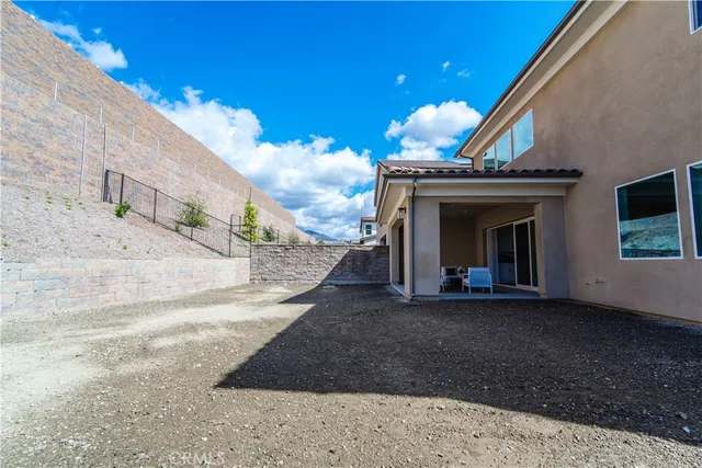 a view of a grey house with a yard