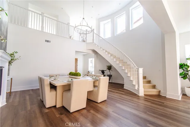 a living room with wooden floor and entryway