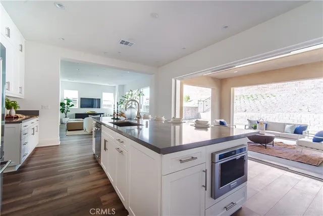 a large kitchen with stainless steel appliances granite countertop a lot of counter space and a sink