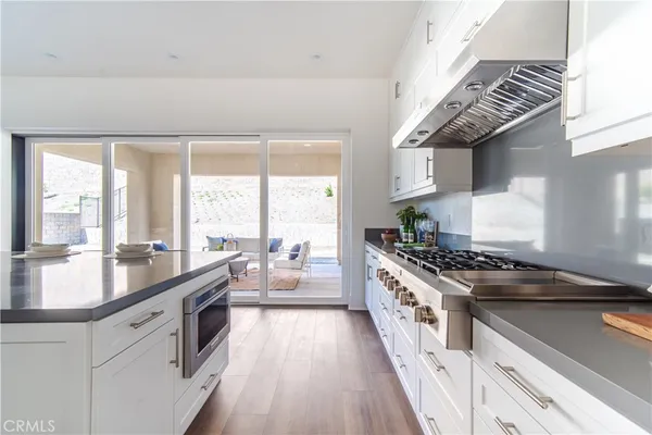 a large white kitchen with a large window