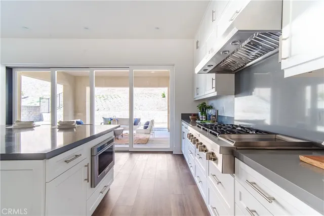 a large white kitchen with a large window