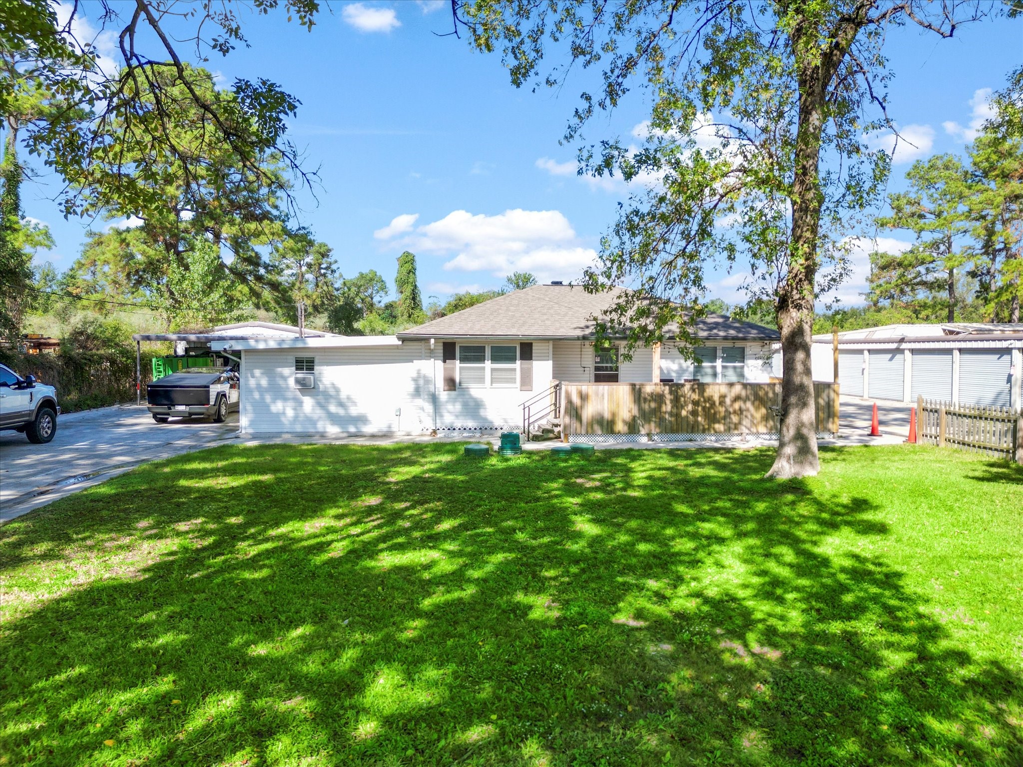 9902 Franklin Road Houston, TX 77070 - Photo 2 of 43 a view of a house with a big yard and large trees