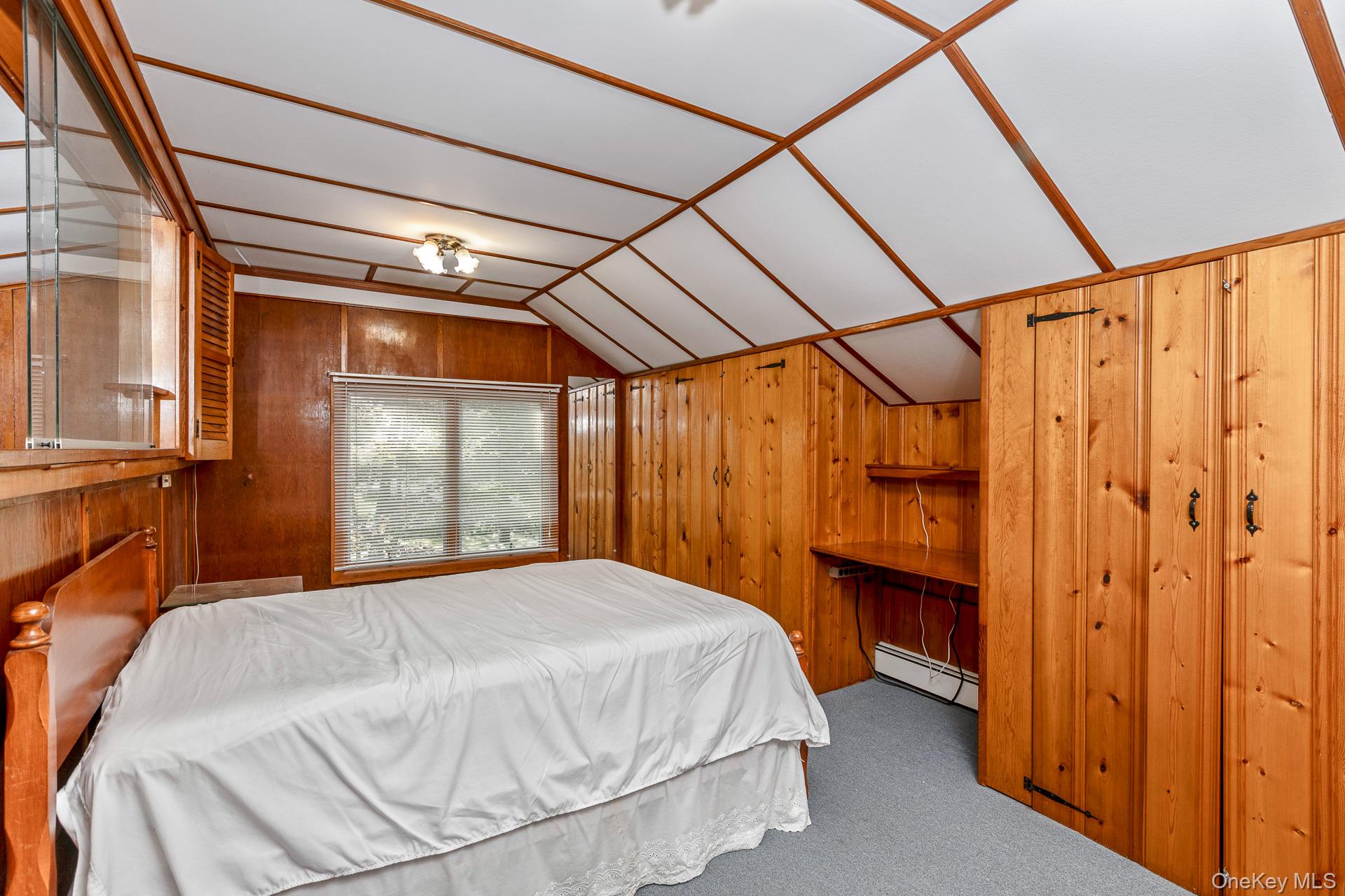 261 Elm Road West Mastic Beach, NY 11951 - Photo 15 of 22 a bedroom with a bed and a mirror