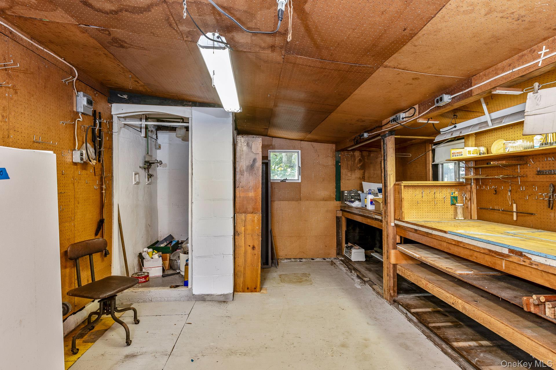 261 Elm Road West Mastic Beach, NY 11951 - Photo 16 of 22 a view of a storage room with wooden shelves