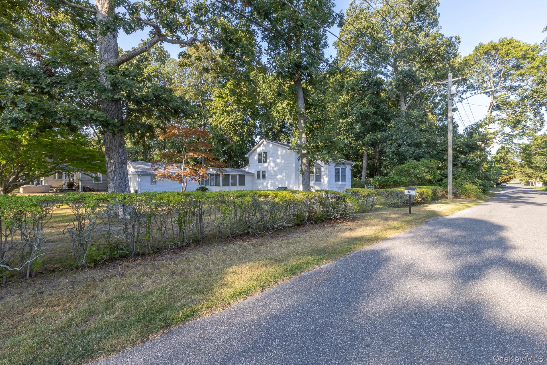 261 Elm Road West Mastic Beach, NY 11951 - Photo 19 of 22 a view of a street with large trees