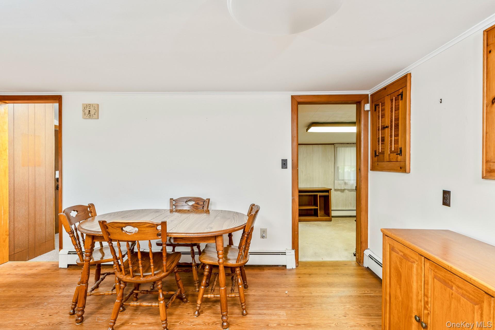 261 Elm Road West Mastic Beach, NY 11951 - Photo 9 of 22 a view of a dining room with furniture and wooden floor