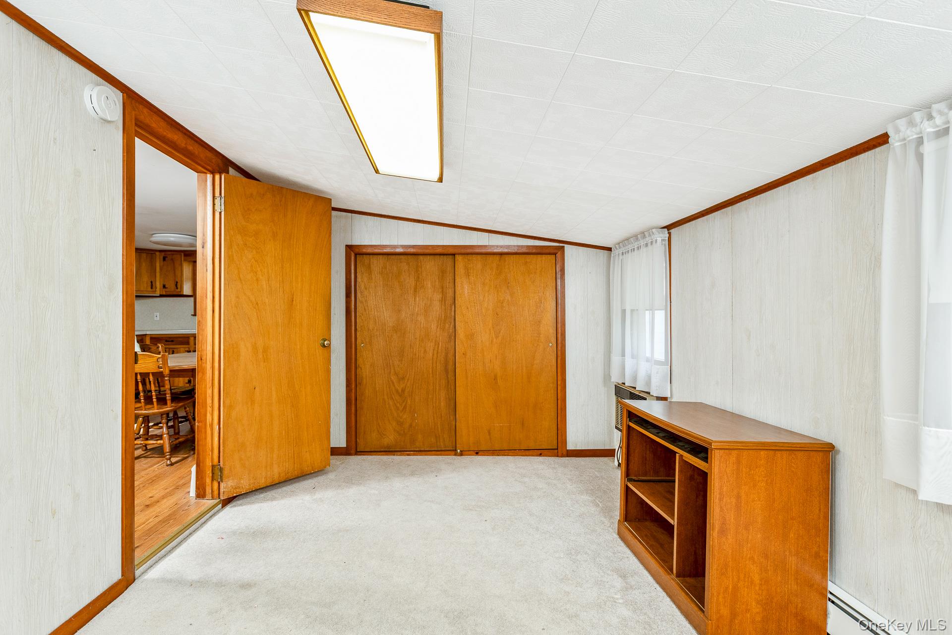 261 Elm Road West Mastic Beach, NY 11951 - Photo 10 of 22 a view of room with window and a ceiling fan