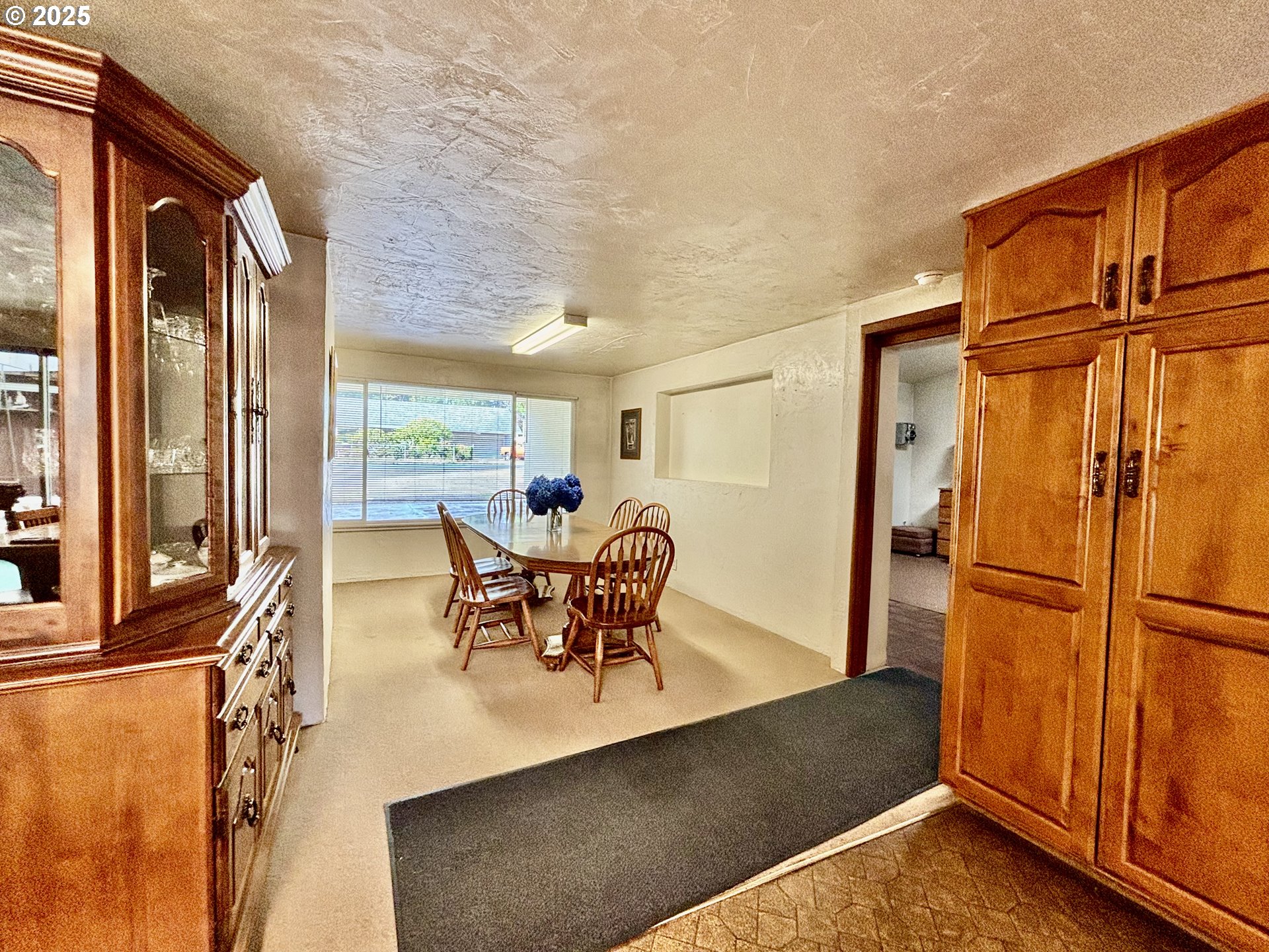 4990 Mitchell Loop Road Florence, OR 97439 - Photo 14 of 37 a dining room with furniture and a floor to ceiling window