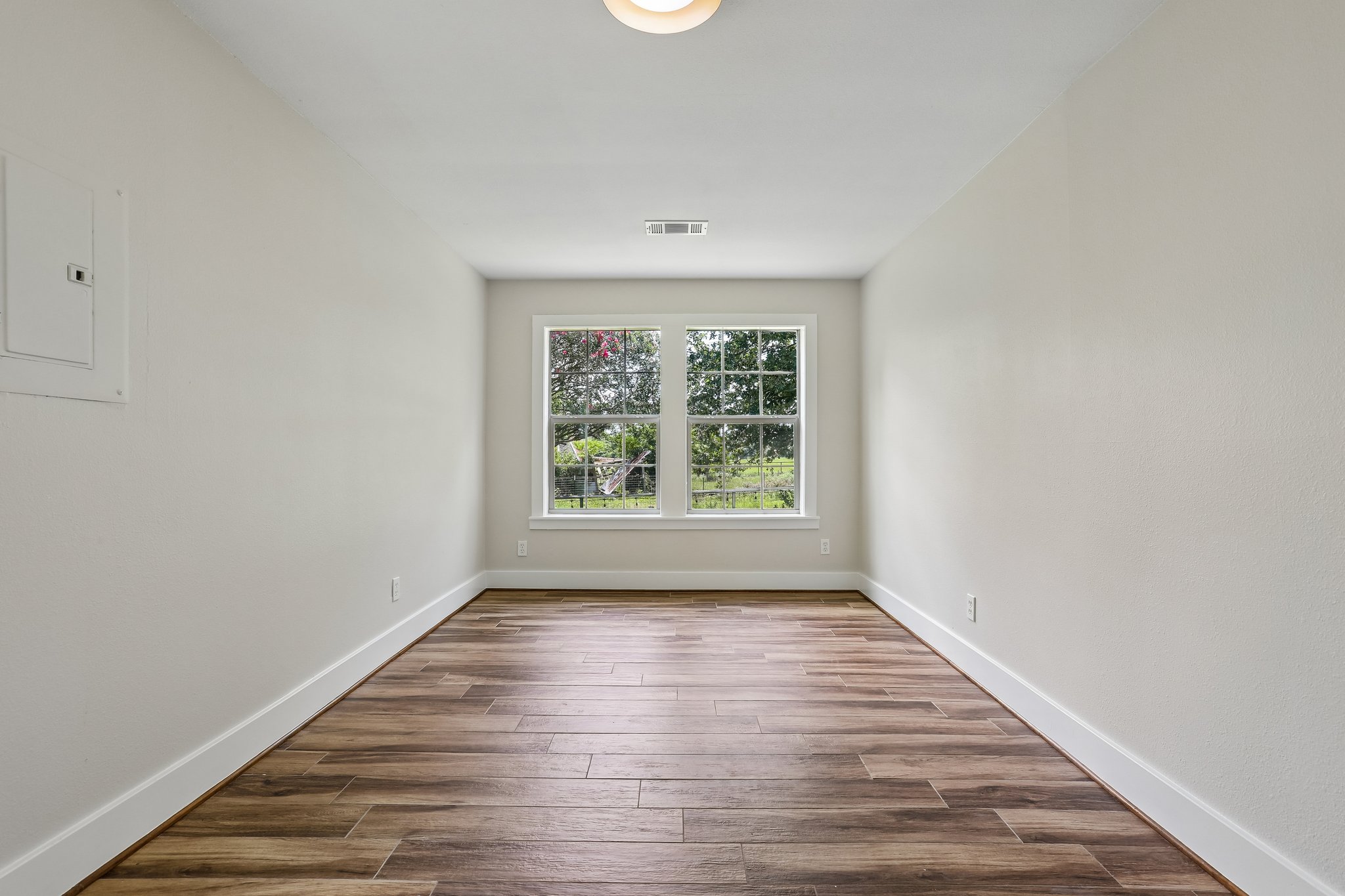 2089 Farm To Market Road 1704 Elgin, TX 78621 - Photo 14 of 31 Bright windows illuminate the richly patterned wood flooring in this versatile space.