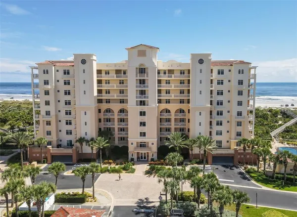 a view of a tall building and a yard